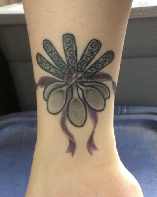 Black And Grey Spoons Tied With Ribbon Traditional Tattoo On Ankle
