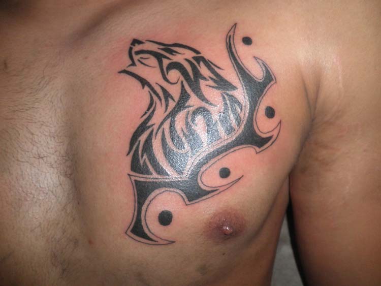 Black And Grey Tribal Wolf Head Howling Tattoo On Left Chest