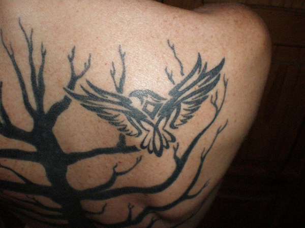 Black Ink Marvelous Bird With Tree Without Leaves Tattoo On Upper Back