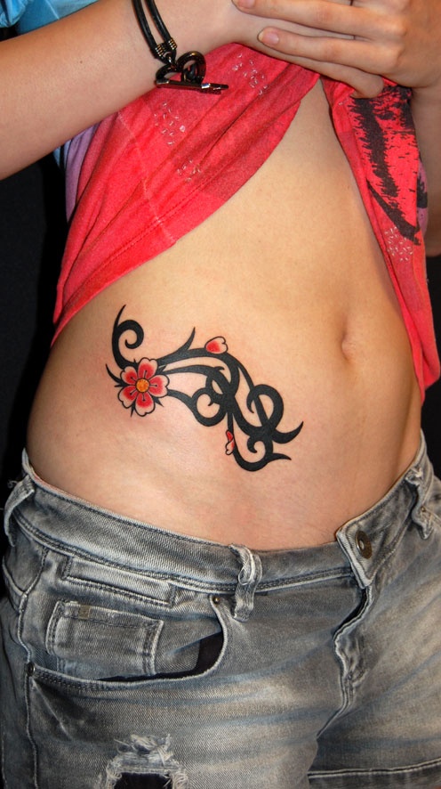 Black Ink Tribal Design With Red Flowers Tattoo On Right Hip