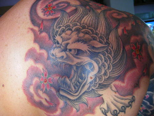 Chinese Angry Foo Dog Tattoo On Upper Back