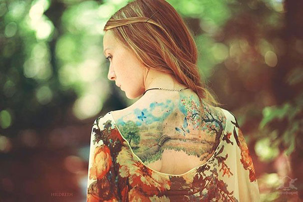 Colorful Artistic Tattoo On Girl Upper Back