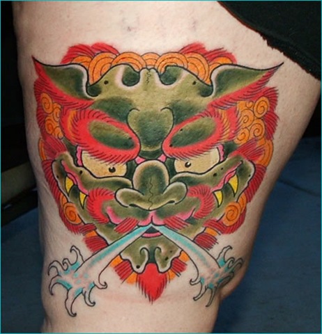 Colorful Foo Dog Head Tattoo On Thigh