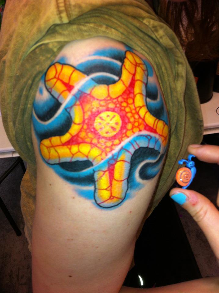 Colorful Starfish With Water Tattoo On Left Shoulder