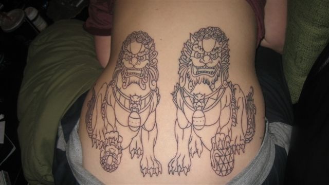 Colorless Foo Dogs Tattoo On Lower Back