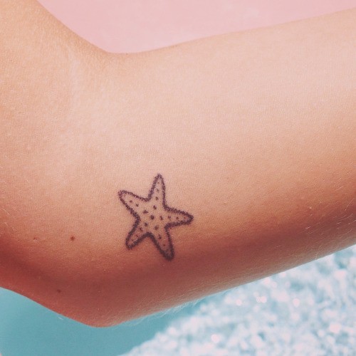 Colorless Simple Starfish Tattoo On Arm