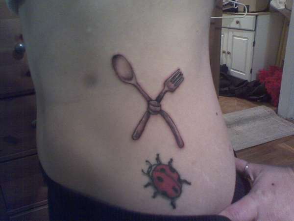 Crossed Spoon And Knife With Beetle Tattoo On Side Rib