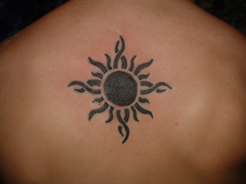 Cute Small Tribal Sun Tattoo On Upper Back
