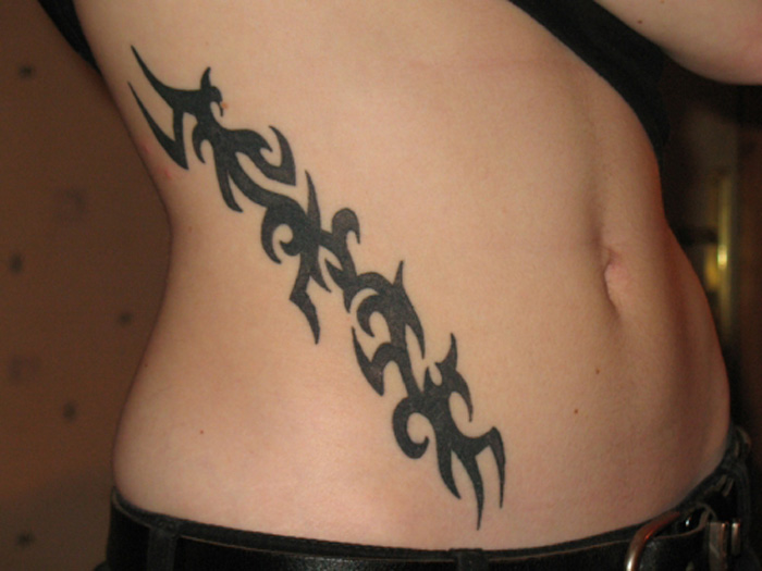 Cute Tribal Design Tattoo On Side Rib For Women