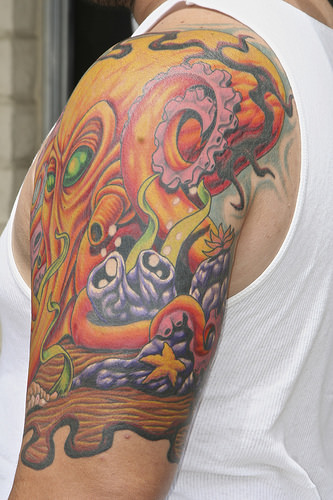 Fantastic Angry Octopus With Starfish Colorful Tattoo On Left Half Sleeve