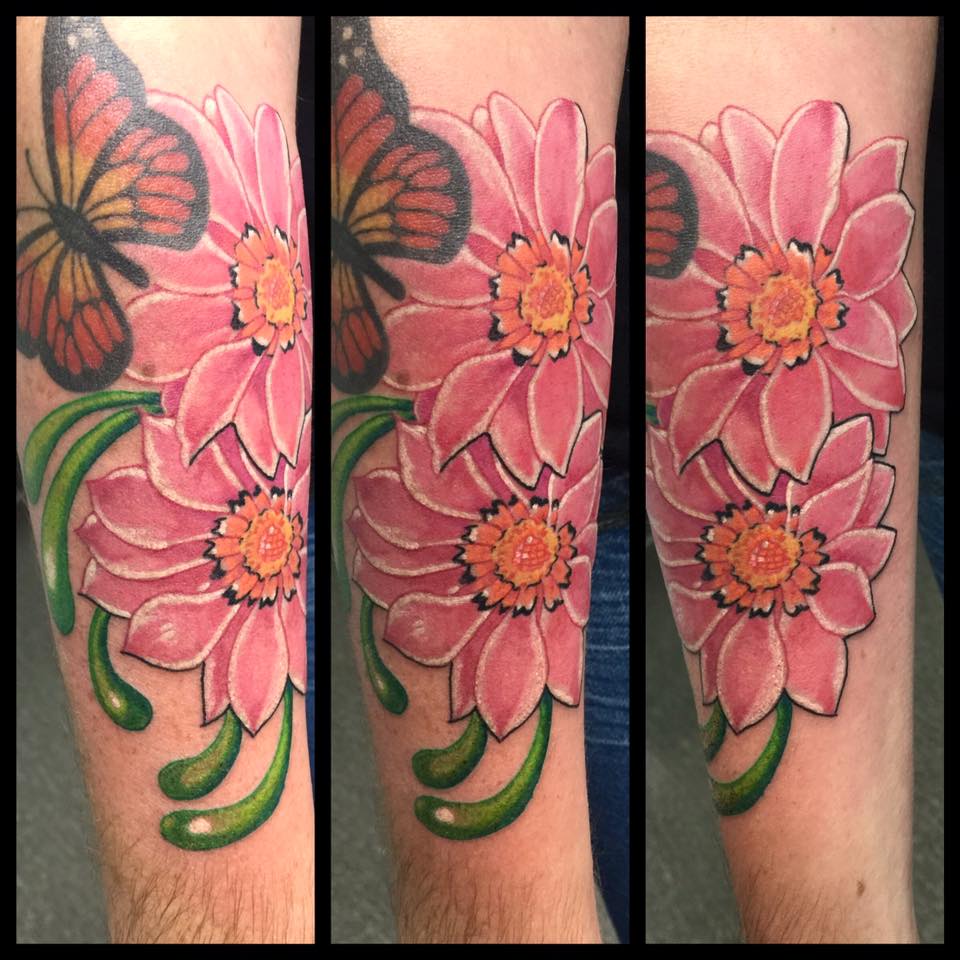 Flowers and butterfly tattoo on arm
