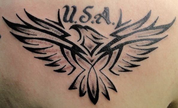 Grey And Black Tribal Eagle With Lettering Tattoo