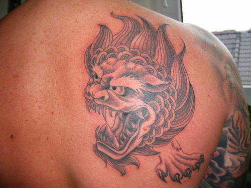 Grey Angry Chinese Foo Dog Head Tattoo On Upper Back