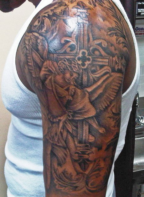 Grey Ink Catholic Tattoo On Man Left Half Sleeve