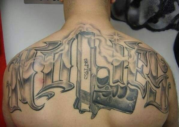Grey Ink Chicano Gun Tattoo On Upper Back