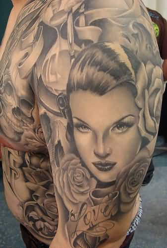 Grey Ink Chicano Tattoo On Man Left Shoulder