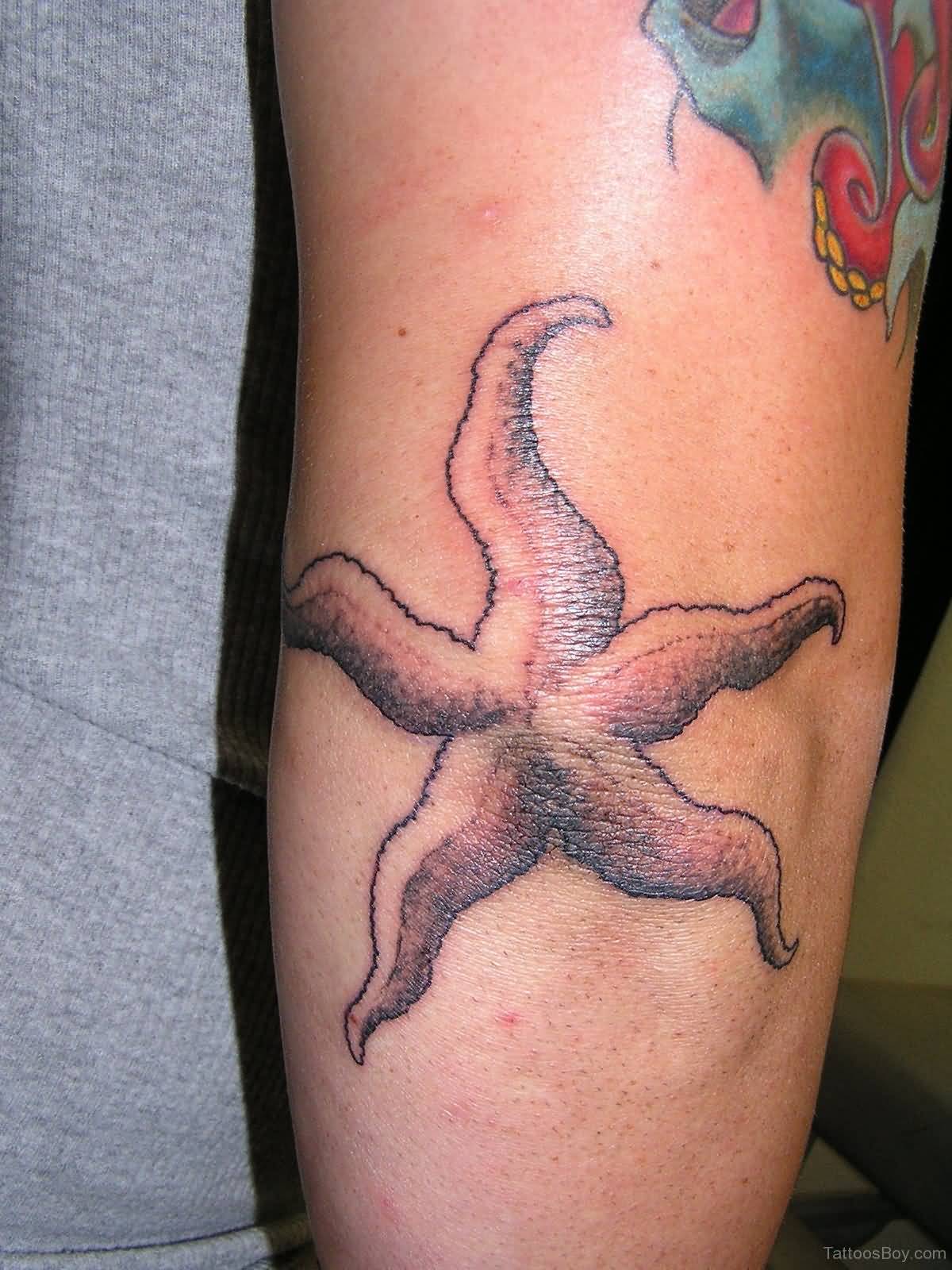 Grey Ink Starfish Tattoo On Elbow