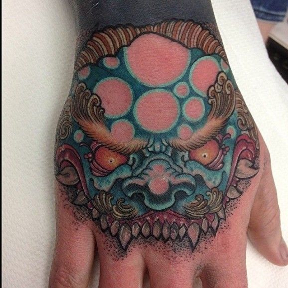 Impressive Foo Dog Head Colorful Tattoo On Hand