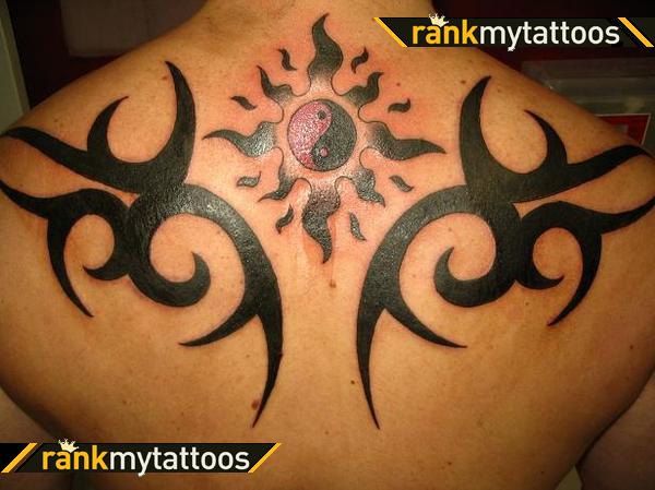 Impressive Yin Yang Tribal Sun Tattoo On Upper Back