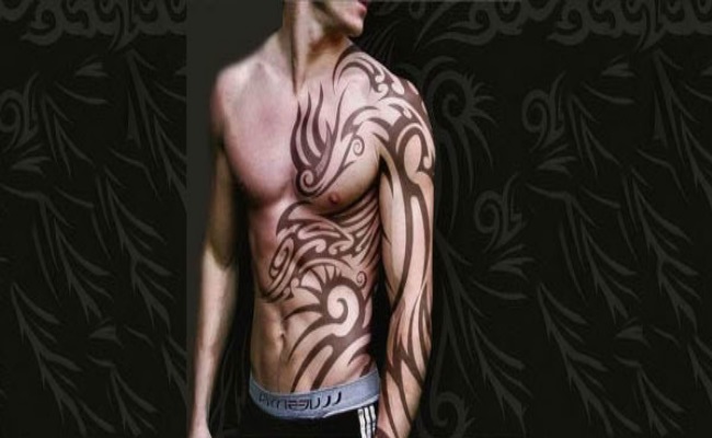 Light Brown Color Celtic Tribal Tattoo On Full Sleeve And Side Rib