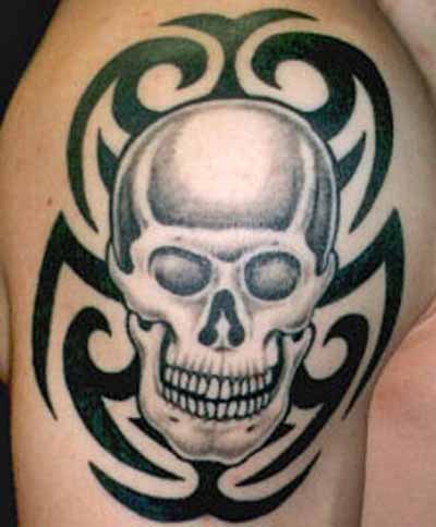 Light Grey Color Skull With Tribal Design Tattoo On Right Shoulder
