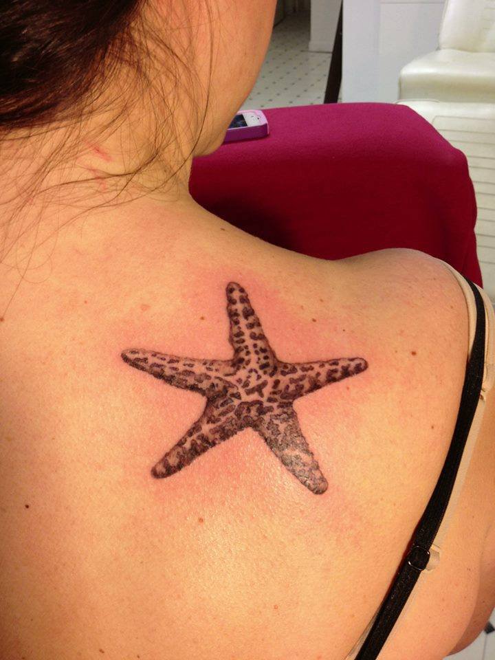 Nice Black And Grey Starfish Tattoo On Upper Back Shoulder