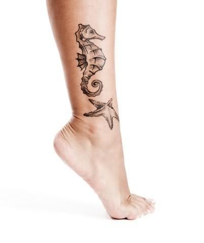 Nice Grey Color Seahorse With Starfish Tattoo On Leg