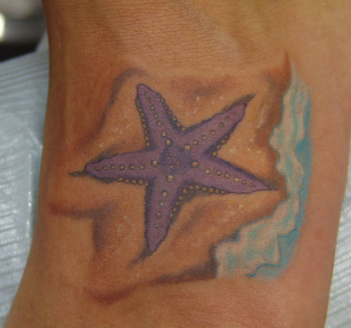 Nice Purple Starfish With Water Tattoo On Foot