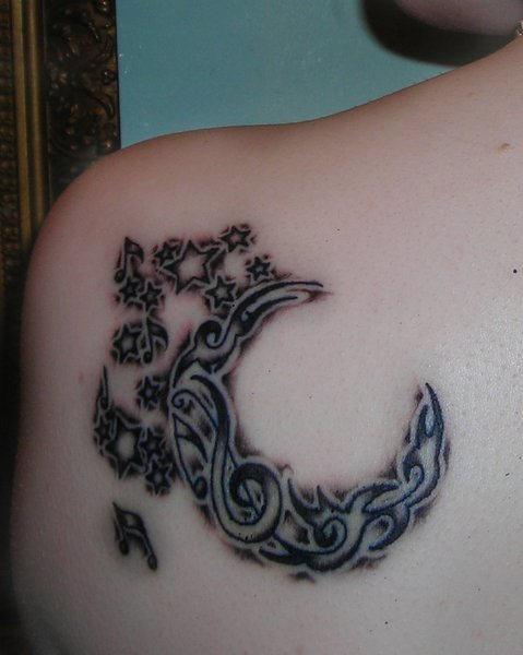 Outstanding Tribal Half Moon With Music Notes And Star Tattoo On Left Back Shoulder