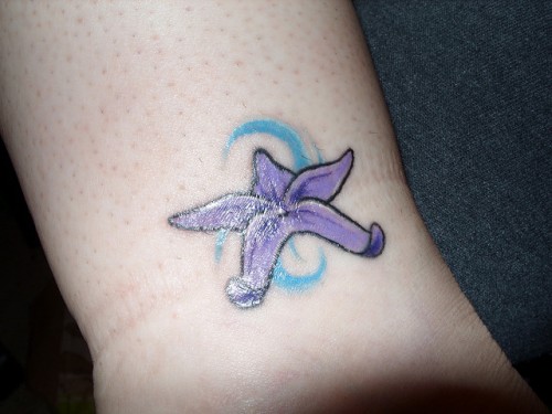 Purple Color Starfish Simple Tattoo On Wrist