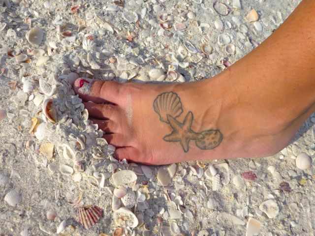 Simple Starfish With Seashell Tattoo On Foot