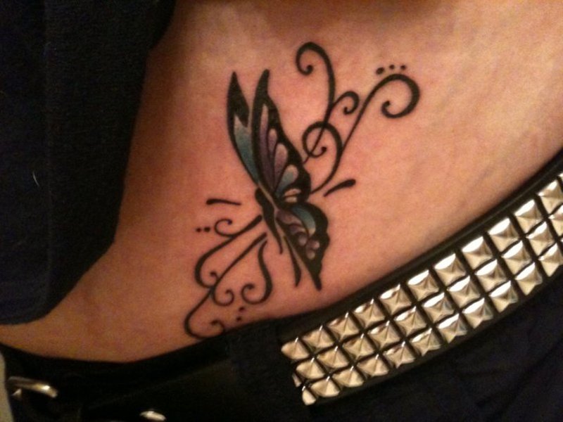 Small And Nice Butterfly With Tribal Design Tattoo On Hip