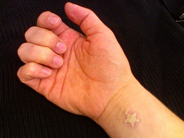 Small White Ink Starfish Tattoo On Wrist