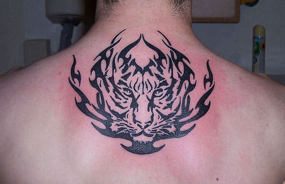 Stunning Black Ink Tribal Tiger Face Tattoo On Upper Back