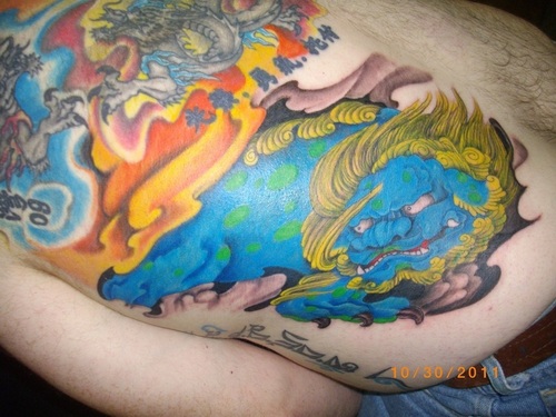 Superb Japanese Foo Dog With Flames And Dragon Colorful Tattoo On Back