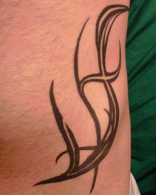 Tribal Design Tattoo On Left Hip