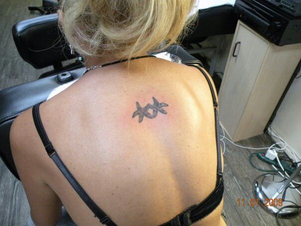Two Tiny Starfishes Tattoo On Upper Back