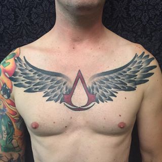 Winged Assassins Creed Logo Tattoo On Chest