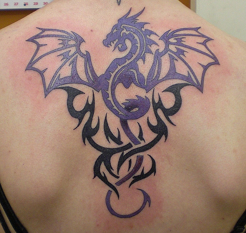 Wonderful Purple Tribal Dragon Tattoo On Upper Back