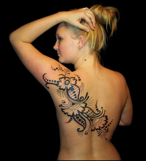 Wonderful Tribal Design With Flowers Tattoo On Upper Back For Women