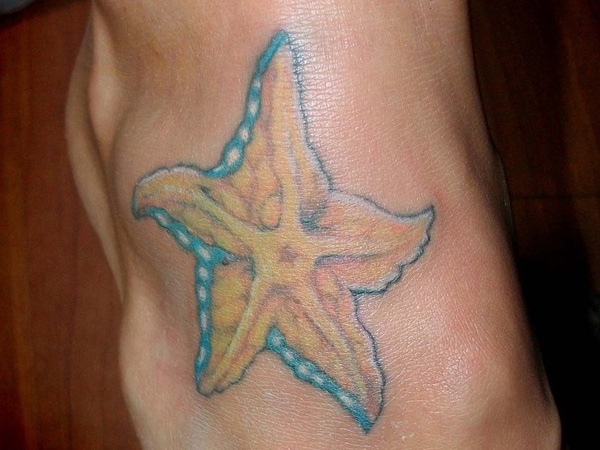 Yellow And Blue Starfish Tattoo On Foot