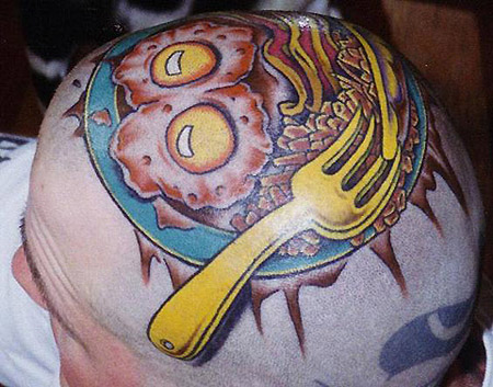Amazing Colorful Yellow Fork With Eggs On Plate Tattoo On Head