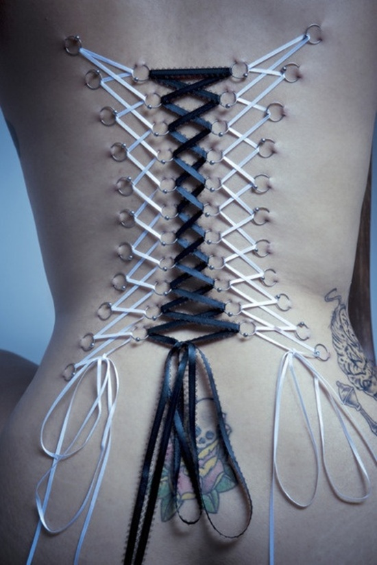 Beautiful Corset Piercing With White And Black Ribbon