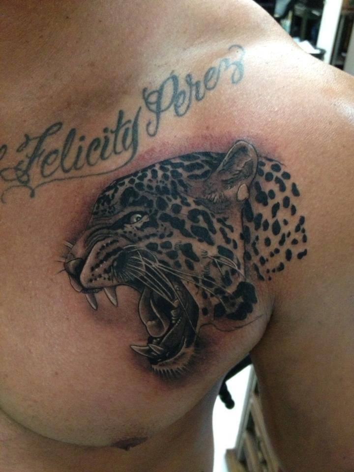Black Ink Roaring Jaguar Face Tattoo On Front Shoulder