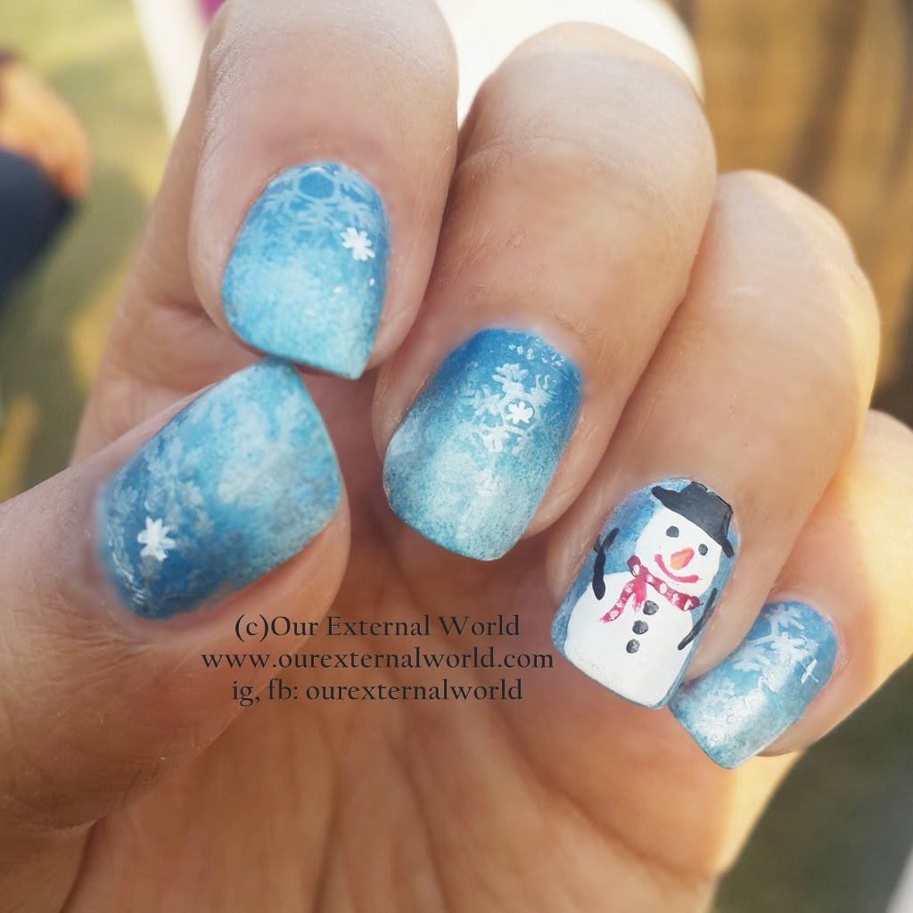 Blue Nails With Snowflakes Design And Snowman Design Winter Nail Art