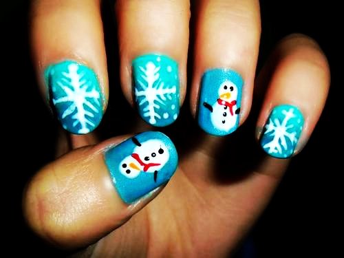 Blue Nails With White Snowflakes And Snowman Winter Nail Art Design