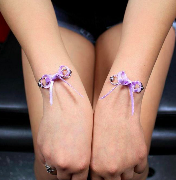 Corset Bow Piercings On Both Wrists