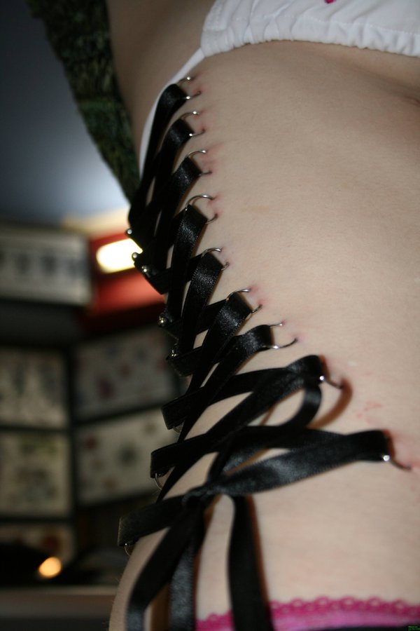 Corset Piercing On Girl Side Rib by Kastrosama