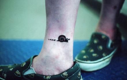 Cute And Small Brown Ink Snail Tattoo On Right Ankle