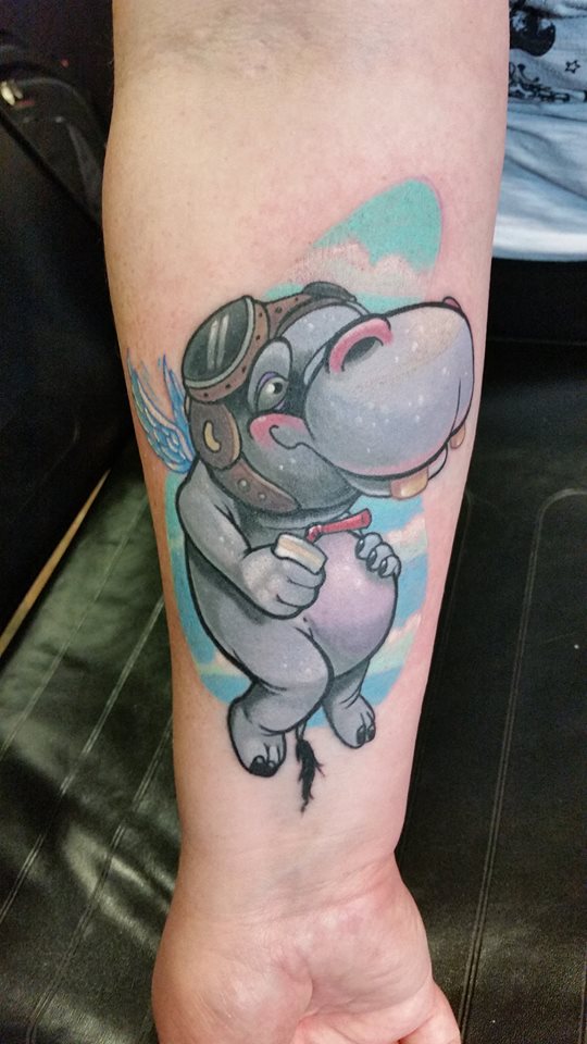Cute Cartoon Hippo Having Wings Tattoo On Forearm